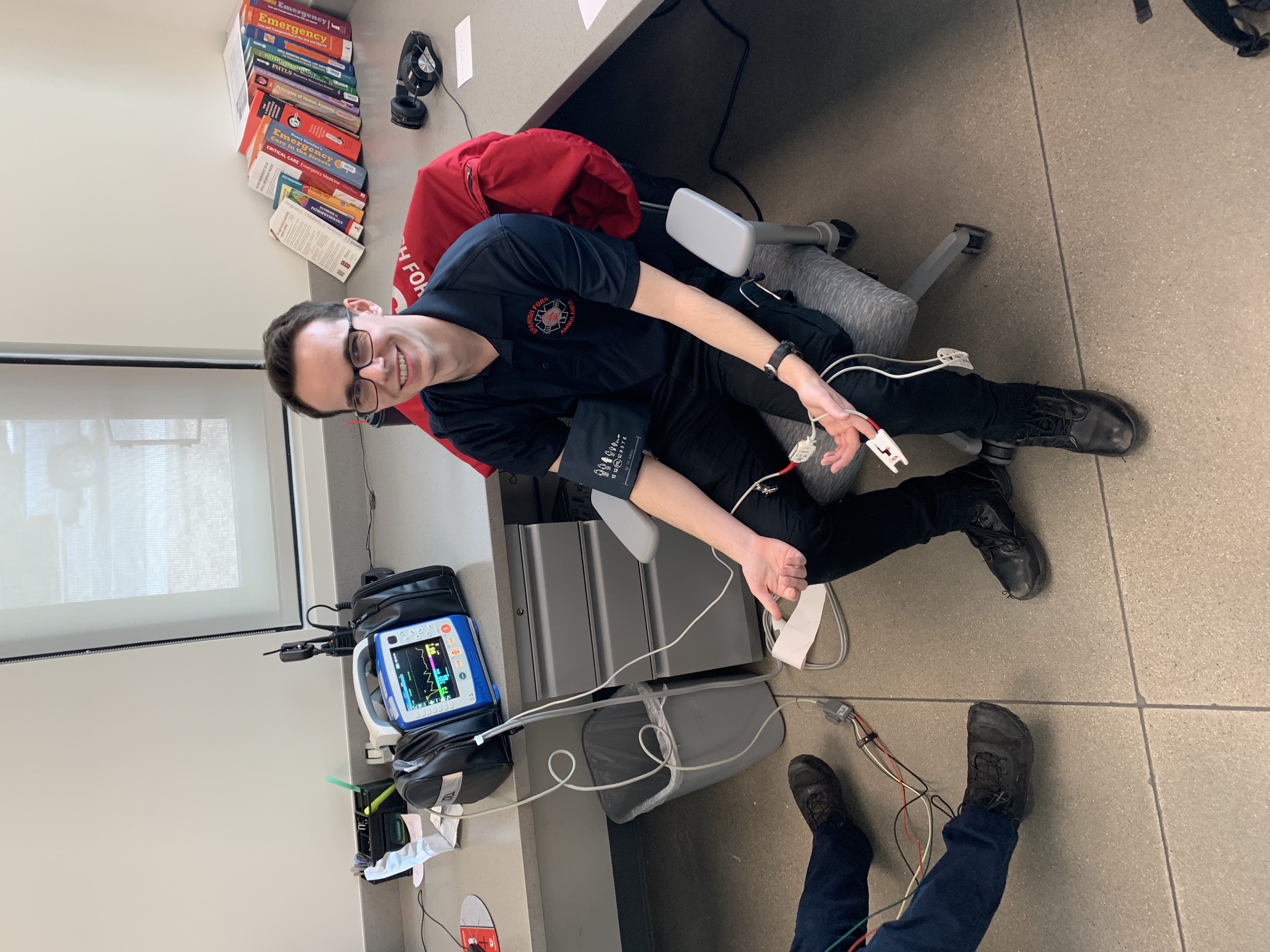 EMT Tate hooked up to the Zoll machine as a demonstration of what the technology can do to monitor heart rate and blood pressure. 